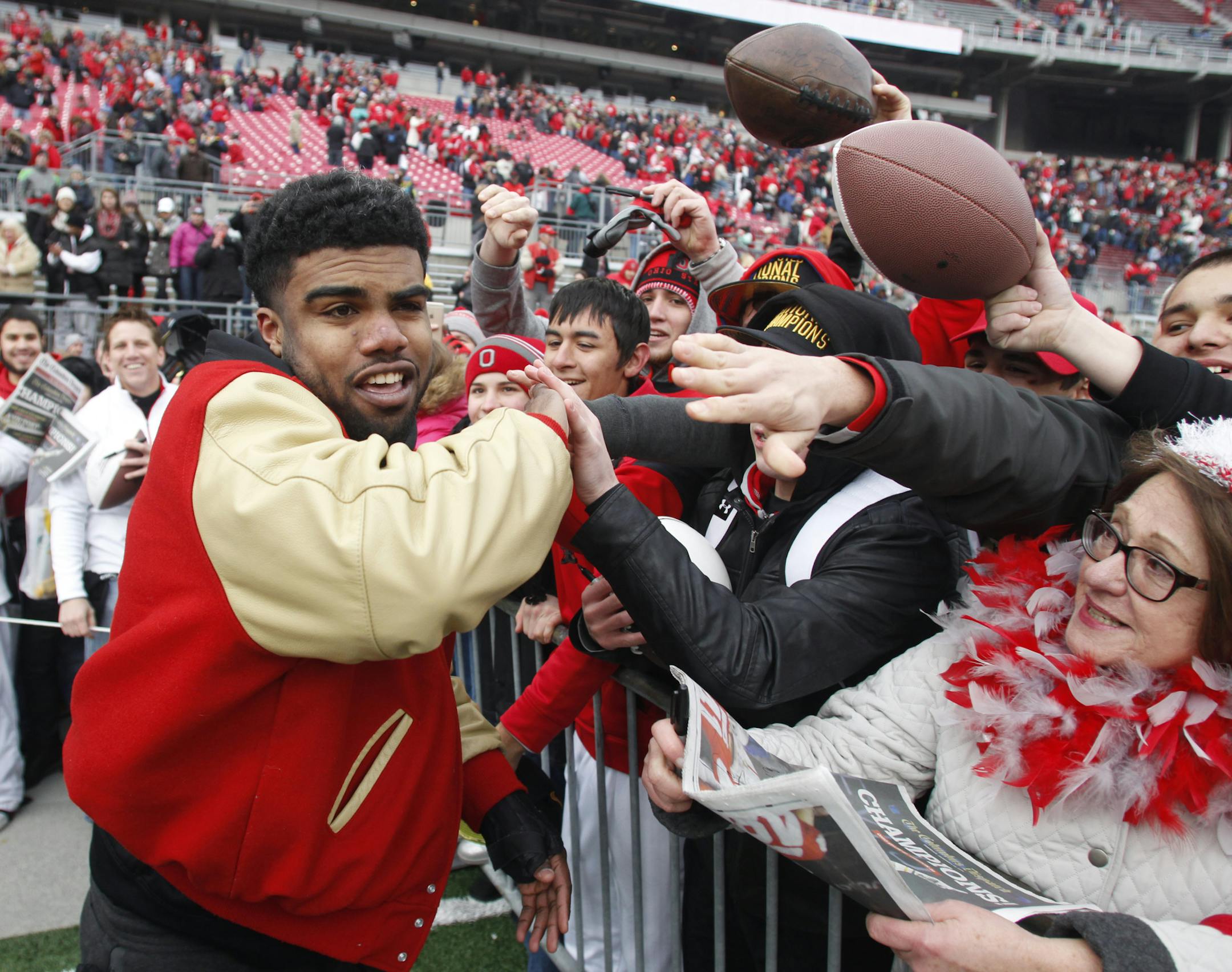 Ohio State running back Ezekiel Elliott greets fans during a celebration of the Buckeye's 2014 College Football Playoff national championship at Ohio Stadium in Columbus, Ohio, Saturday, Jan. 24, 2015. (AP Photo/Paul Vernon)