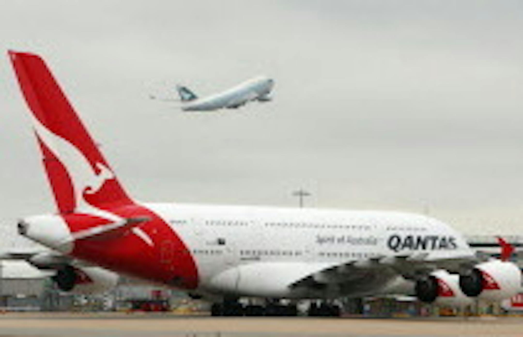 A Qantas plane sits on the tarmac at Heathrow Airport, London Sunday Oct. 30, 2011 stranding passengers after an industrial dispute left hundreds of flights grounded. Tens of thousands of stranded Qantas Airways passengers scrambled to reach their destinations Sunday as the airline, its unions and the Australian government argued in a lengthy arbitration hearing over the abrupt grounding of its entire fleet. (AP Photo/Steve Parsons/PA Wire) UNITED KINGDOM OUT NO SALES NO ARCHIVE