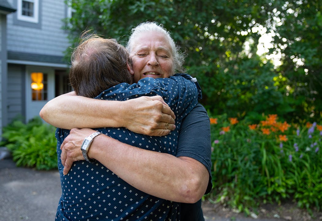 After Bill's death, his sister Julie Lang embraces her son, Charlie Lang.
