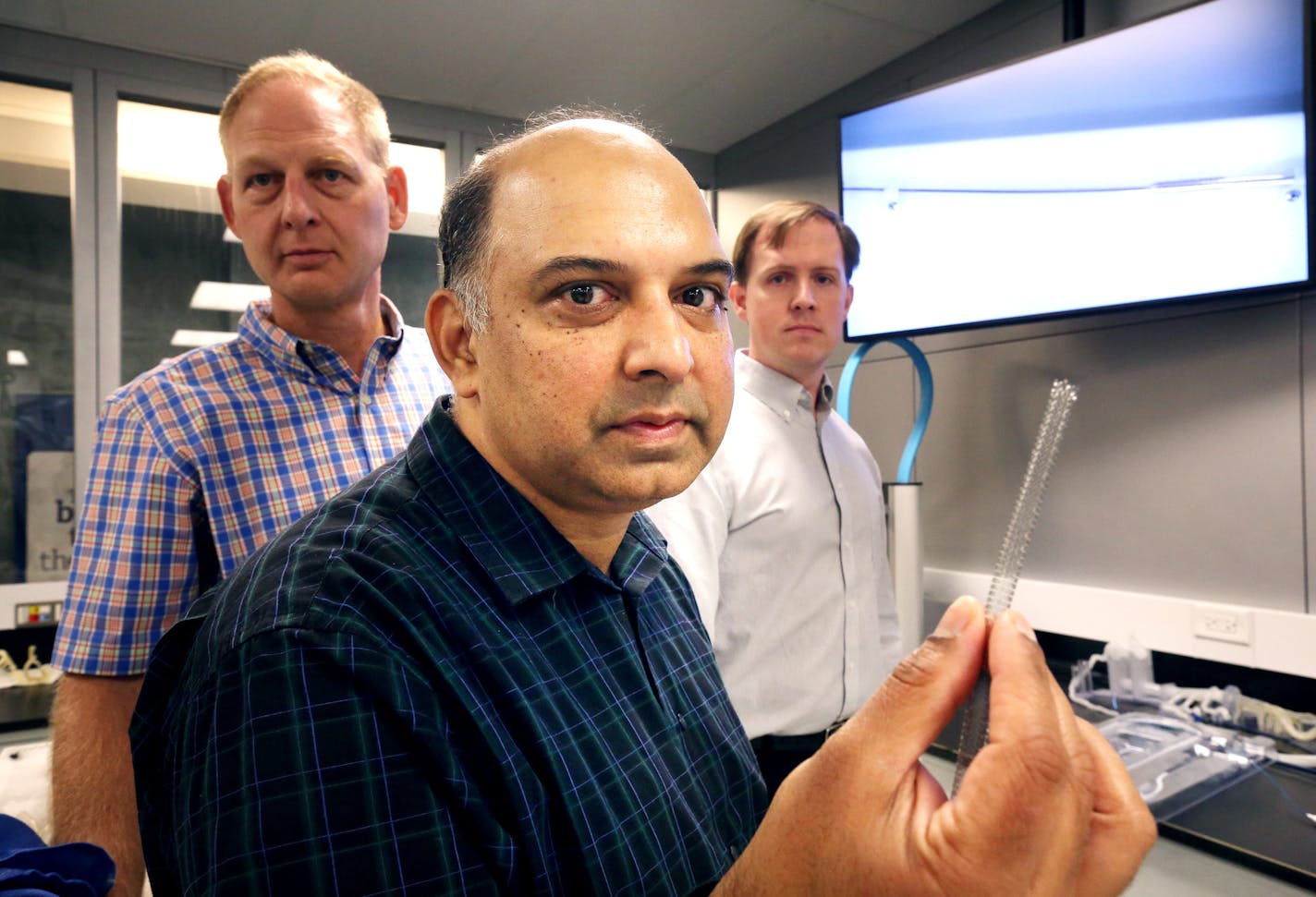 Boston Scientific engineers Jay Kokate (front) holding a peripheral stent; was joined by James Hemerick, (left) and Aaron Foss. The peripheral stent was made by Boston Scientific and designed in Maple Grove. September 2, 2015 in Maple Grove, MN. ] Jerry Holt/ Jerry.Holt@Startribune.com