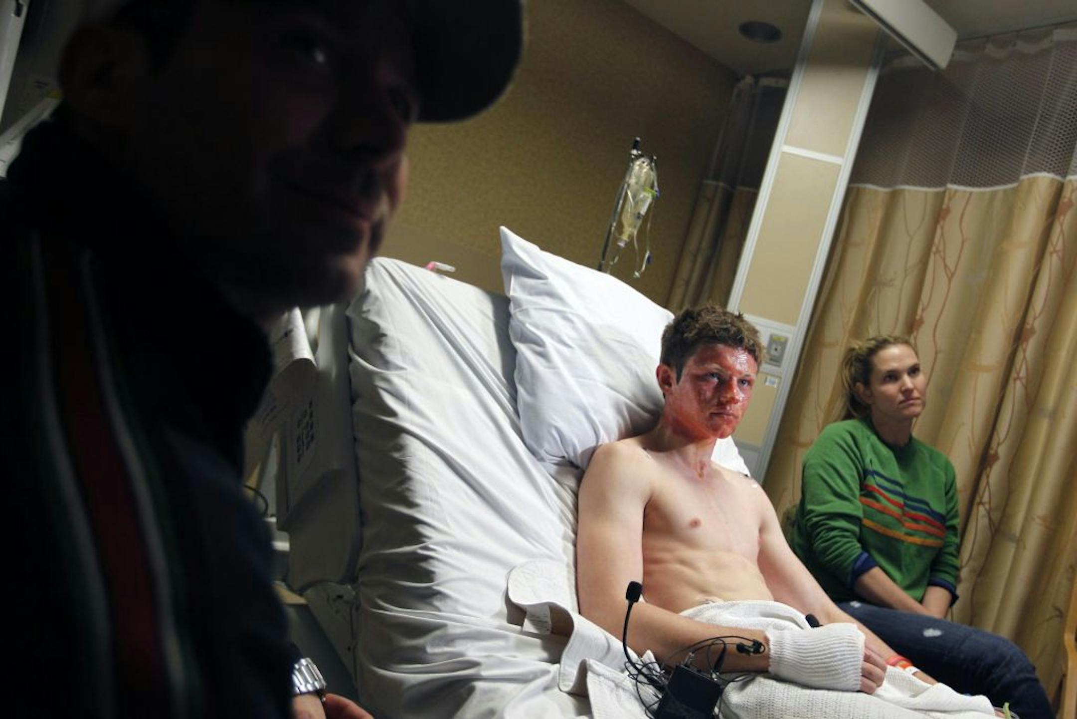 Dane Neuberger sat with his father, Gus, and his mother, Lisa. The family is focusing on Dane's recovery and not on missteps by the school or teacher Matthew Achor. "We're not looking for blood from him," Gus said.