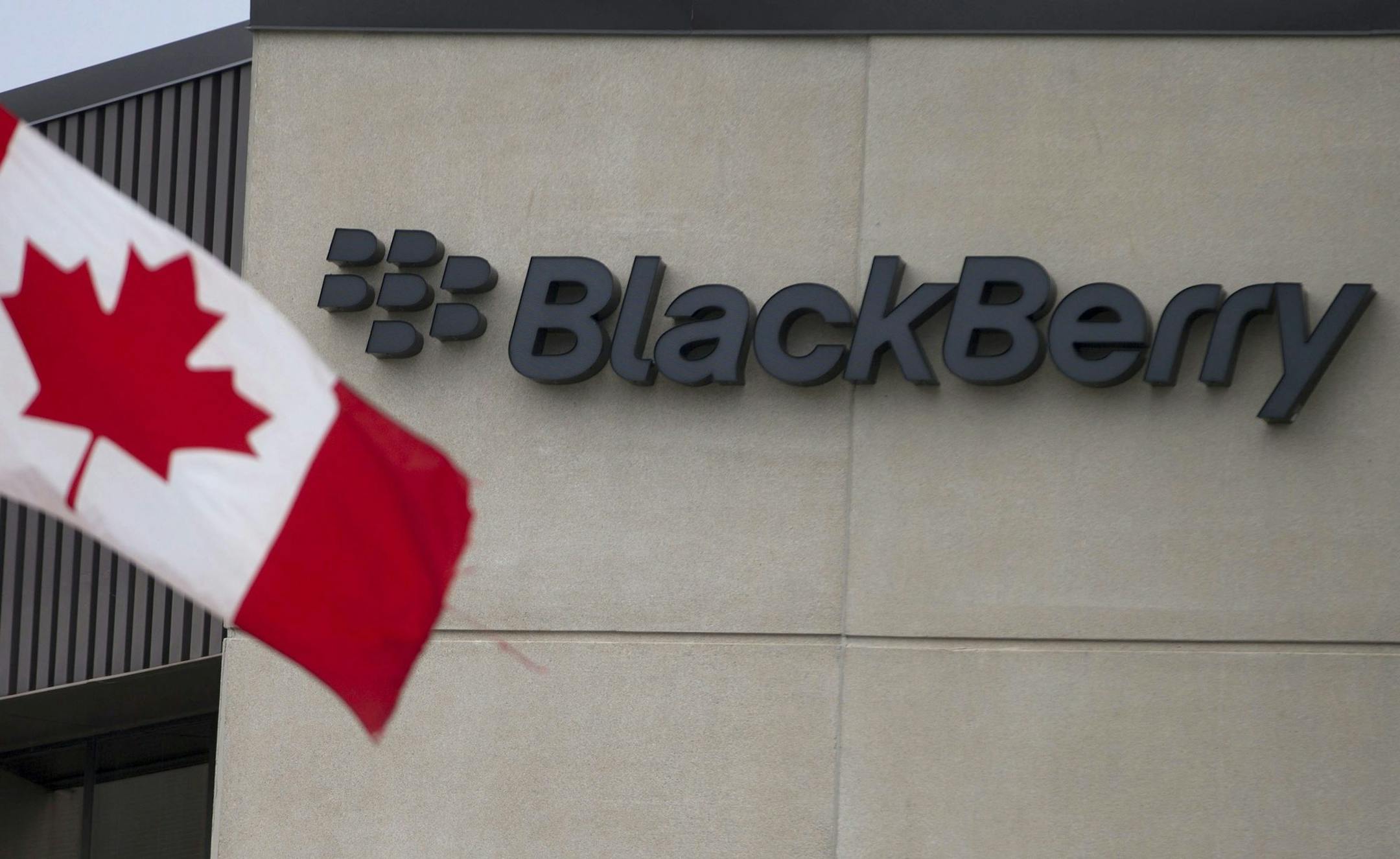 A Canadian flag flies at BlackBerry's headquarters in Waterloo, Ont., Tuesday, July 9, 2013. Research In Motion has won formal approval to change its name to BlackBerry. The Canadian company announced plans for the name change in January, when it unveiled new phones running a revamped operating system called BlackBerry 10. The company hopes the new devices will be more competitive with iPhones and Android devices. (AP Photo/The Canadian Press, Geoff Robins) ORG XMIT: MIN2013070911465630