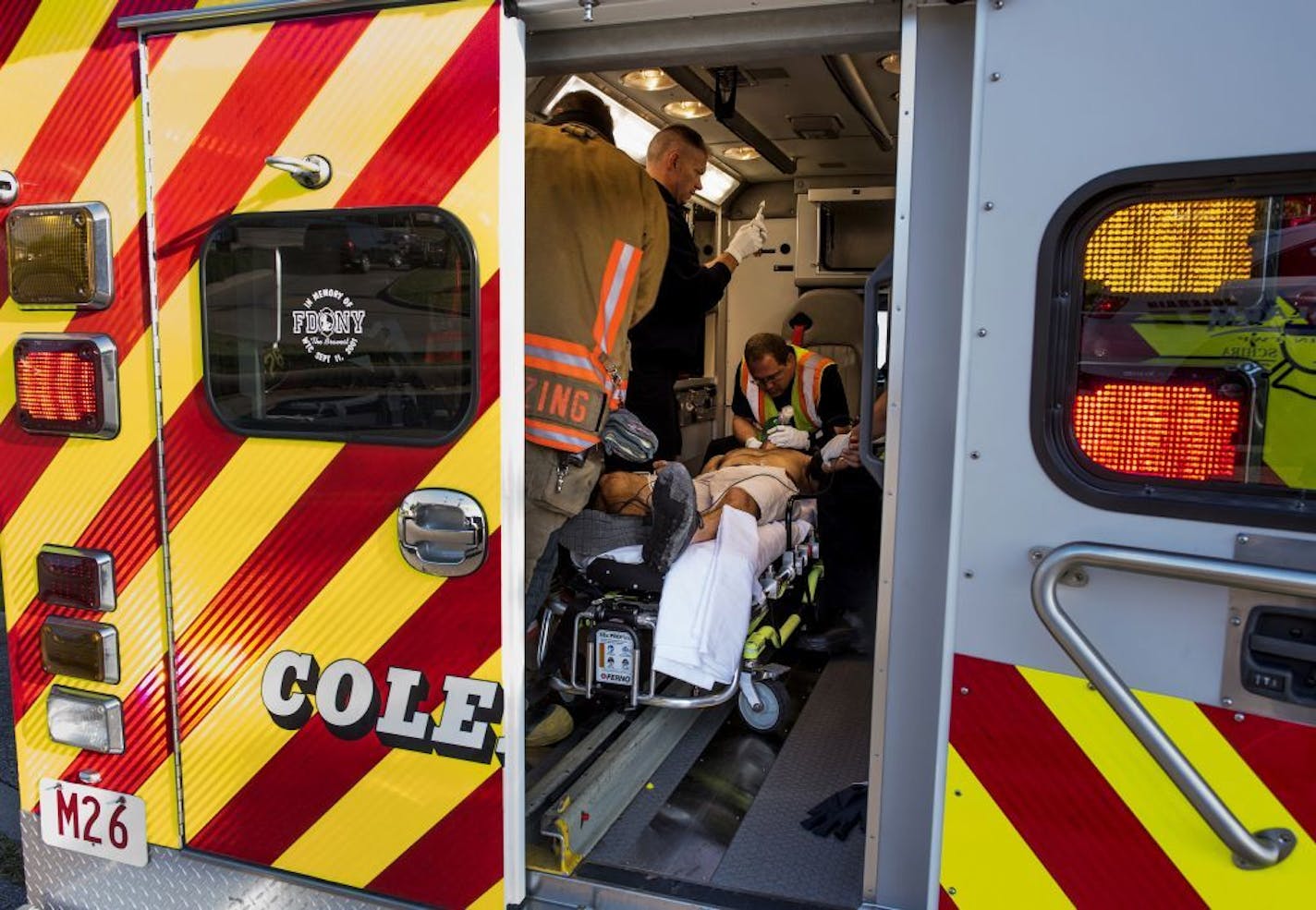 FILE -- Medics from the Colerain Township Fire Dept. resuscitate a victim of an auto accident who overdosed on heroin, in Colerain Township, Ohio, Sept. 2, 2016. While suicides, drug overdoses, and alcoholism were the main causes of increased death rates among people in midlife, other medical conditions also contributed, authors of a study published on Nov. 26 in JAMA reported.