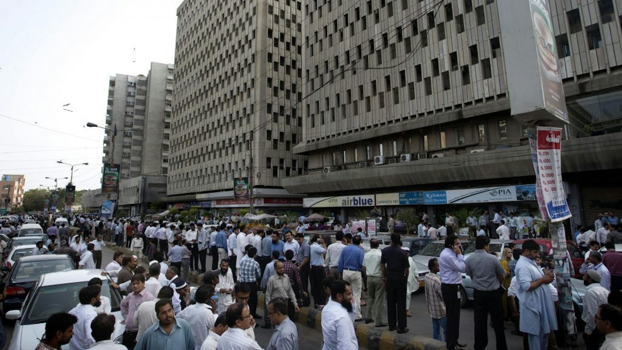 People evacuate buildings and gather on road after a tremor of an earthquake was felt in Karachi, Pakistan, Tuesday, April 16, 2013. A major earthquake described as the strongest to hit Iran in more than half a century flatted homes and offices Tuesday near Iran's border with Pakistan, killing at least tens of people in the sparsely populated region and swaying buildings as far away as New Delhi and the skyscrapers in Dubai and Bahrain.