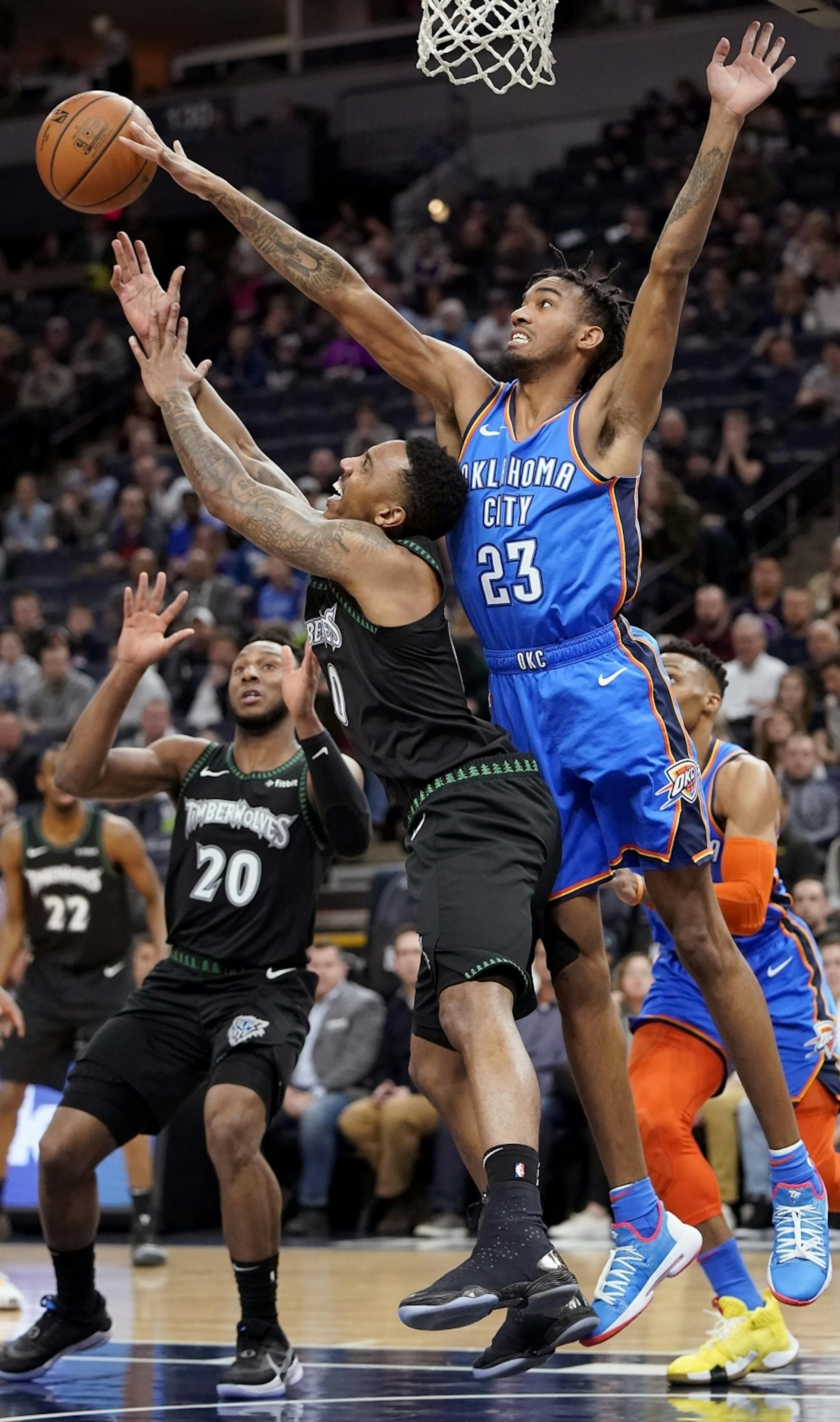 Minnesota Timberwolves guard Jeff Teague (0) shoots as Oklahoma City Thunder guard Terrance Ferguson (23) blocks his shot during the first half.