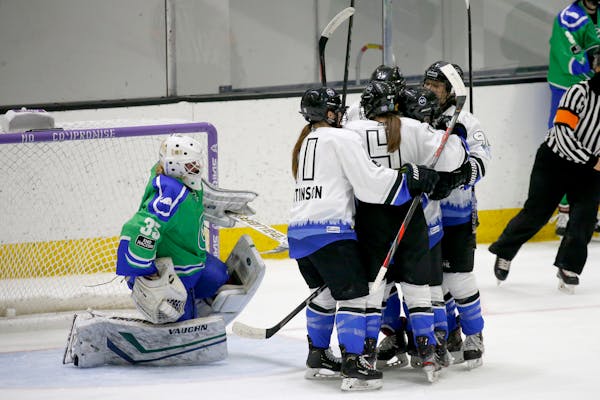 Minnesota Whitecaps players celebrate after scoring against Connecticut Whale goalie Abbie Ives (35) during the second period of a semifinal in the NW