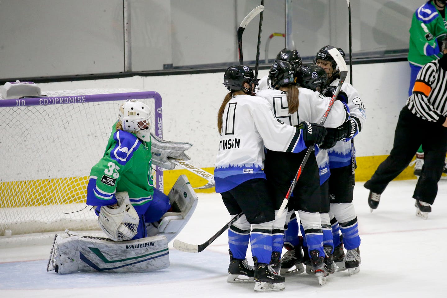 Minnesota Whitecaps players celebrate after scoring against Connecticut Whale goalie Abbie Ives (35) during the second period of a semifinal in the NWHL Isobel Cup hockey tournament Friday, March 26, 2021, in Boston. (AP Photo/Mary Schwalm)