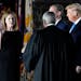 President Donald Trump watches Monday night as Supreme Court Justice Clarence Thomas administers the Constitutional Oath to Amy Coney Barrett on the S
