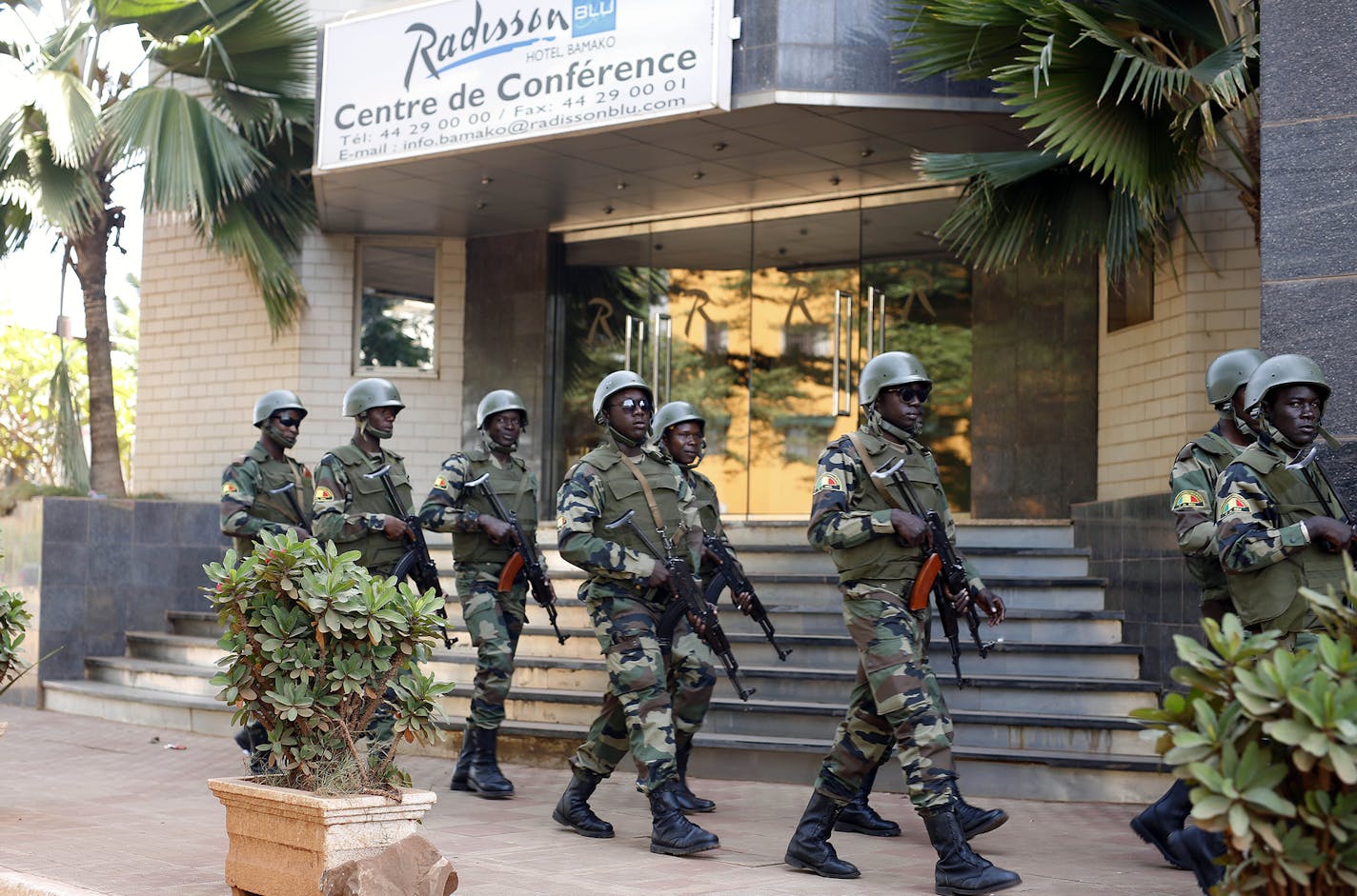 Soldiers from the presidential guard patrol outside the Radisson Blu hotel in Bamako, Mali, Saturday, Nov. 21, 2015, in anticipation of the President's visit. Islamic extremists armed with guns and grenades stormed the luxury Radisson Blu hotel in Mali's capital Friday morning, and security forces worked to free guests floor by floor. (AP Photo/Jerome Delay) ORG XMIT: MIN2015112515112034