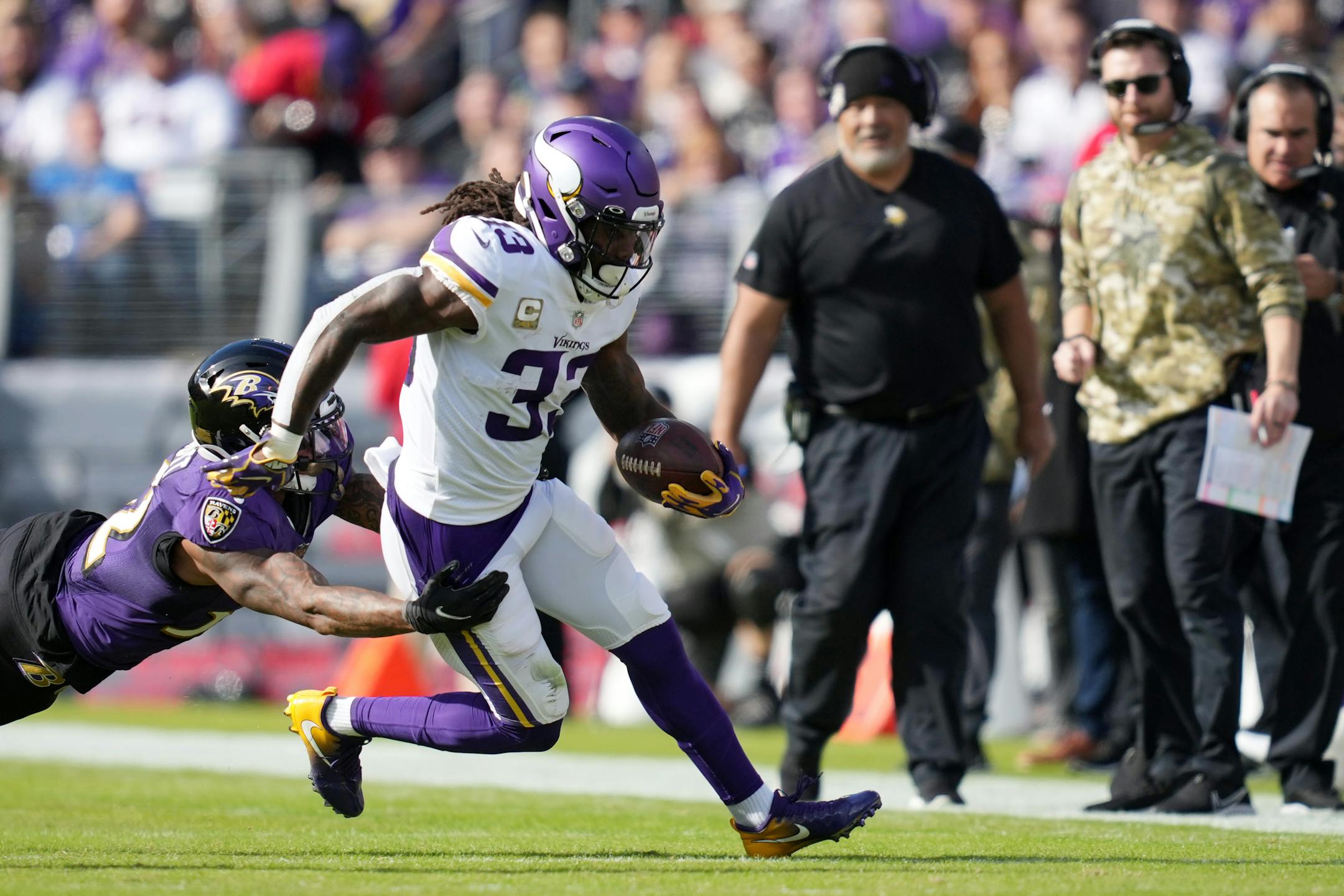 Ravens free safety DeShon Elliott (32) leapt after Vikings running back Dalvin Cook (33) as he rushed the ball in the first quarter of an NFL game between the Minnesota Vikings and the Baltimore Ravens Sunday, Nov. 7, 2021 at M&T Bank Stadium in Baltimore.