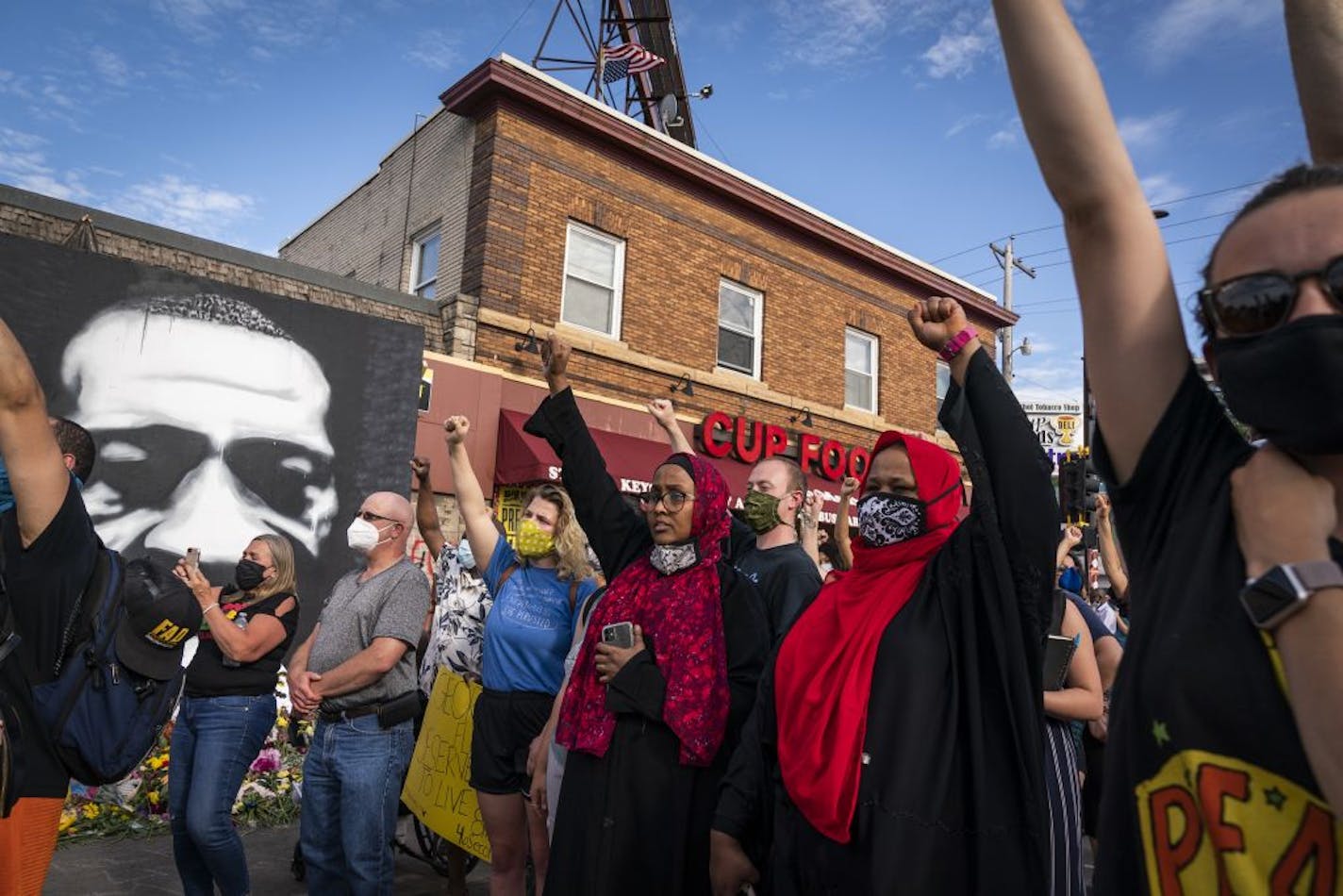 The crowd raised their fists to George Floyd outside of Cup Foods.