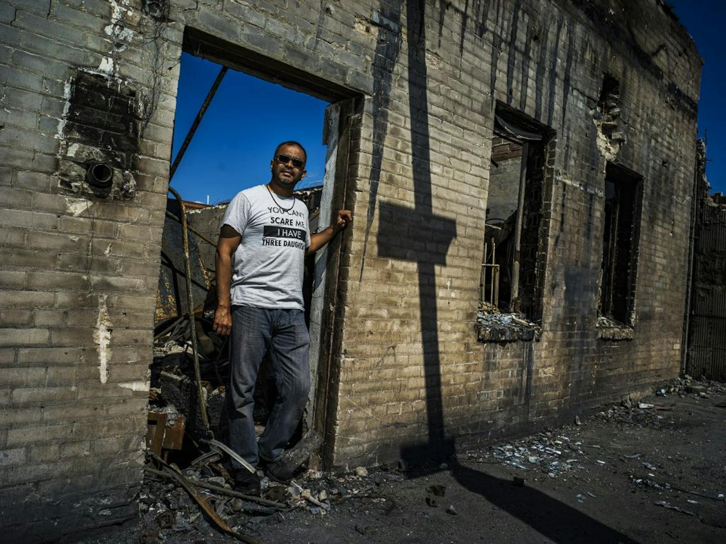 Ruhel Islam, seen in June outside the rubble of his Gandhi Mahal restaurant, owns one of the sites that could receive city funds. He said he has received seven bids ranging from $125,610 to $269,900 for removing debris at the site.