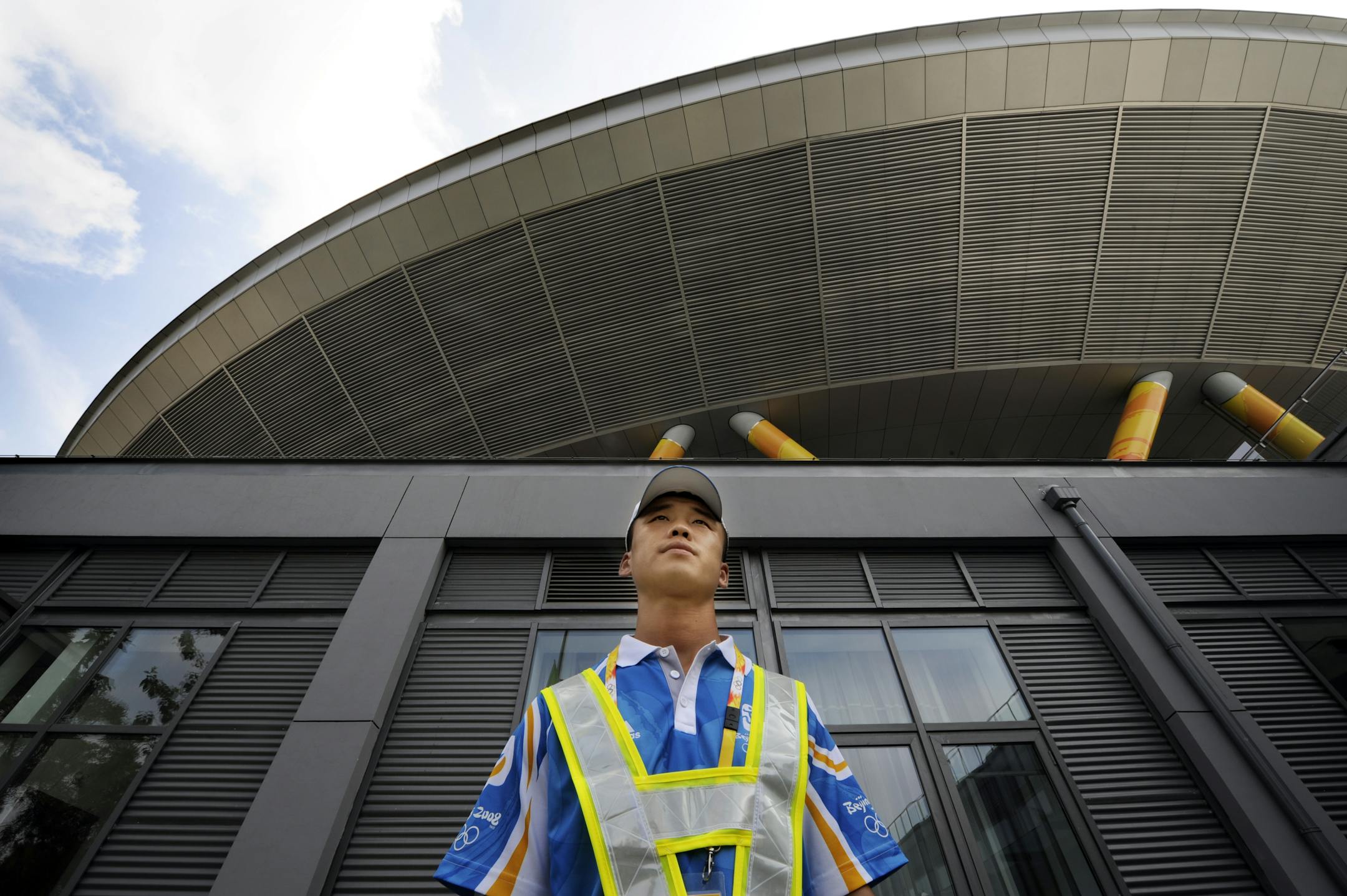Volunteers, such as this young man at the Laoshan Velodrome, are everywhere around Beijing and other venues, eager to greet and assist the thousands of visitors.