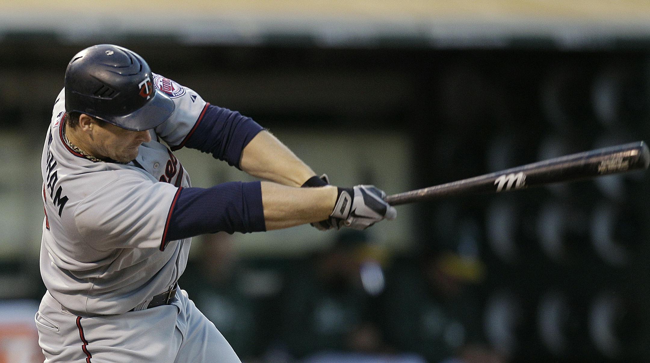 Minnesota's Josh Willingham swings for an RBI single off Oakland's Brandon McCarthy in the second inning Monday.