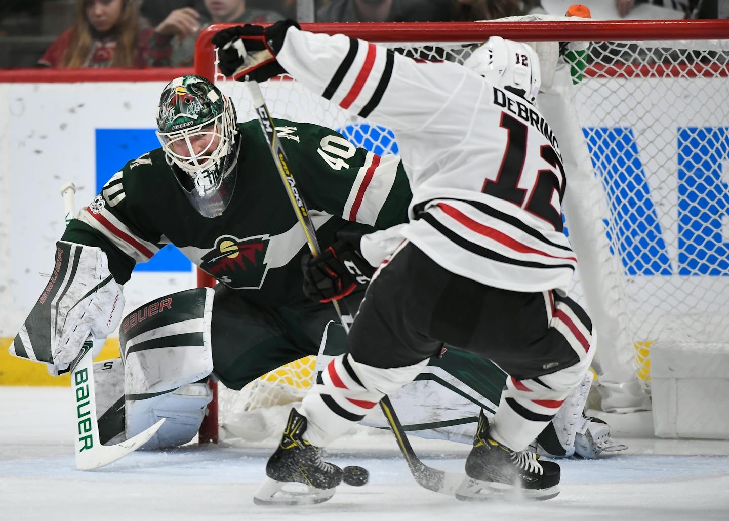 Minnesota Wild goalie Devan Dubnyk (40) eyed the puck before blocking a shot by Chicago Blackhawks right wing Alex DeBrincat (12) in the second period.