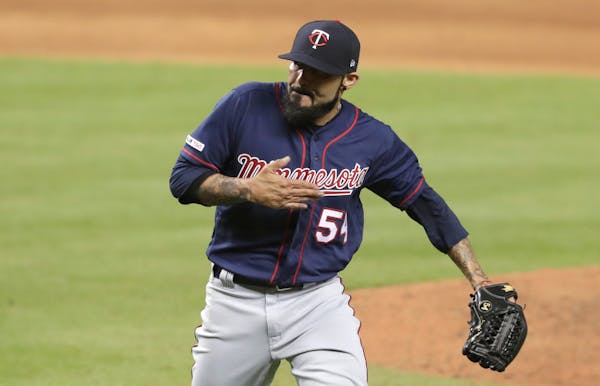 New Twins reliever Sergio Romo pounded his chest after striking out former teammate Martin Prado to end the eighth.