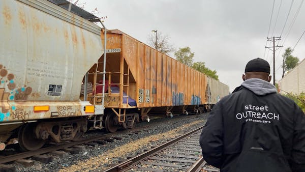 Randy Flowers, a street outreach worker for St. Stephen's Human Services, checks in on someone sheltering in a rail yard. Give to the Max Day is Nov. 