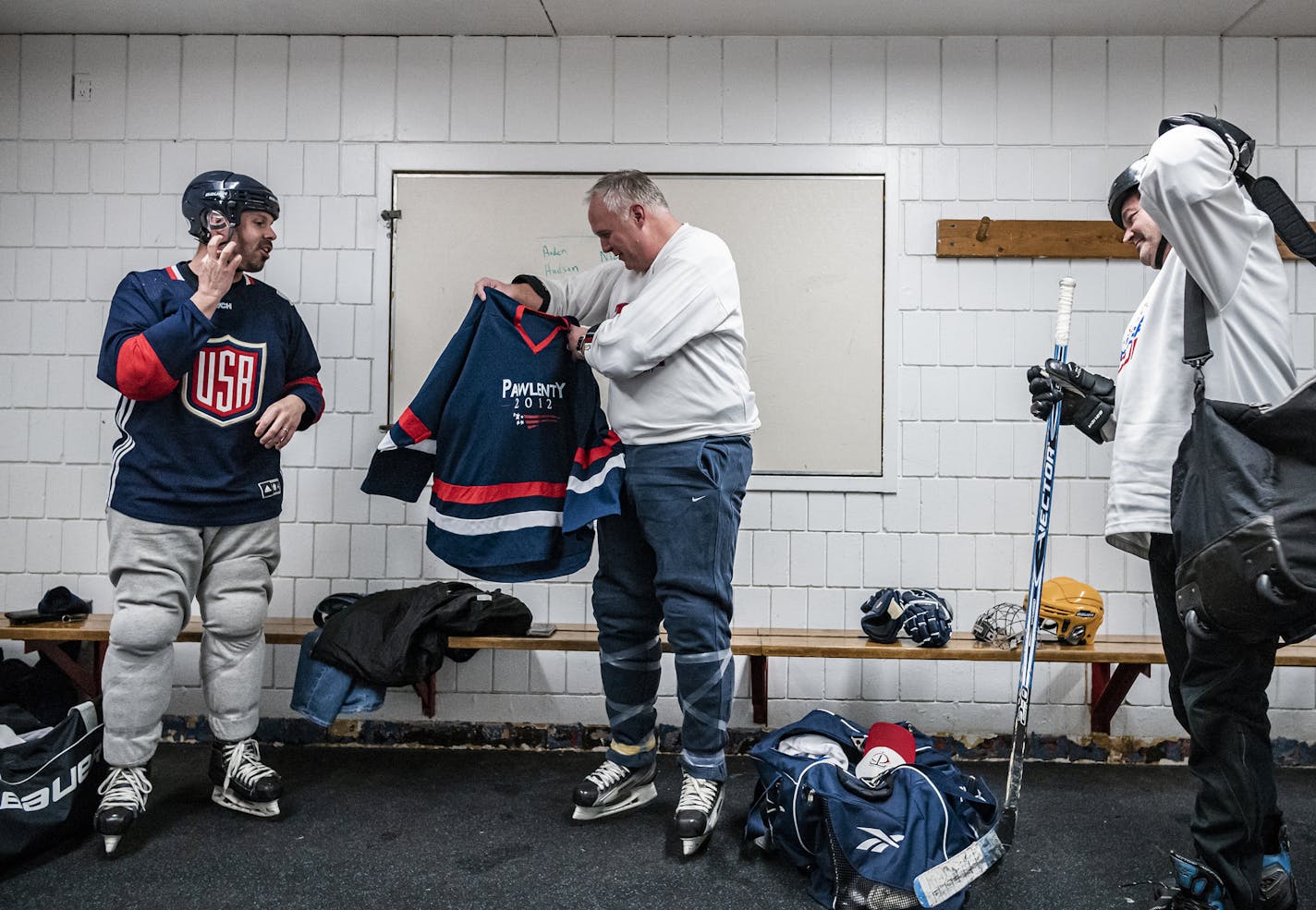 L to R: John Reich, GOP State Senator Paul Anderson, and DFL House Representative Leon Lillie suit up for the game.] For decades, through divisve policy debates and state elections, a group of legislators have upheld a very Minnesotan tradition: ice hockey. Each Sunday night a group plays at the Highland Arena in St. Paul. RICHARD TSONG-TAATARII &#xa5; richard.tsong-taatarii@startribune.com