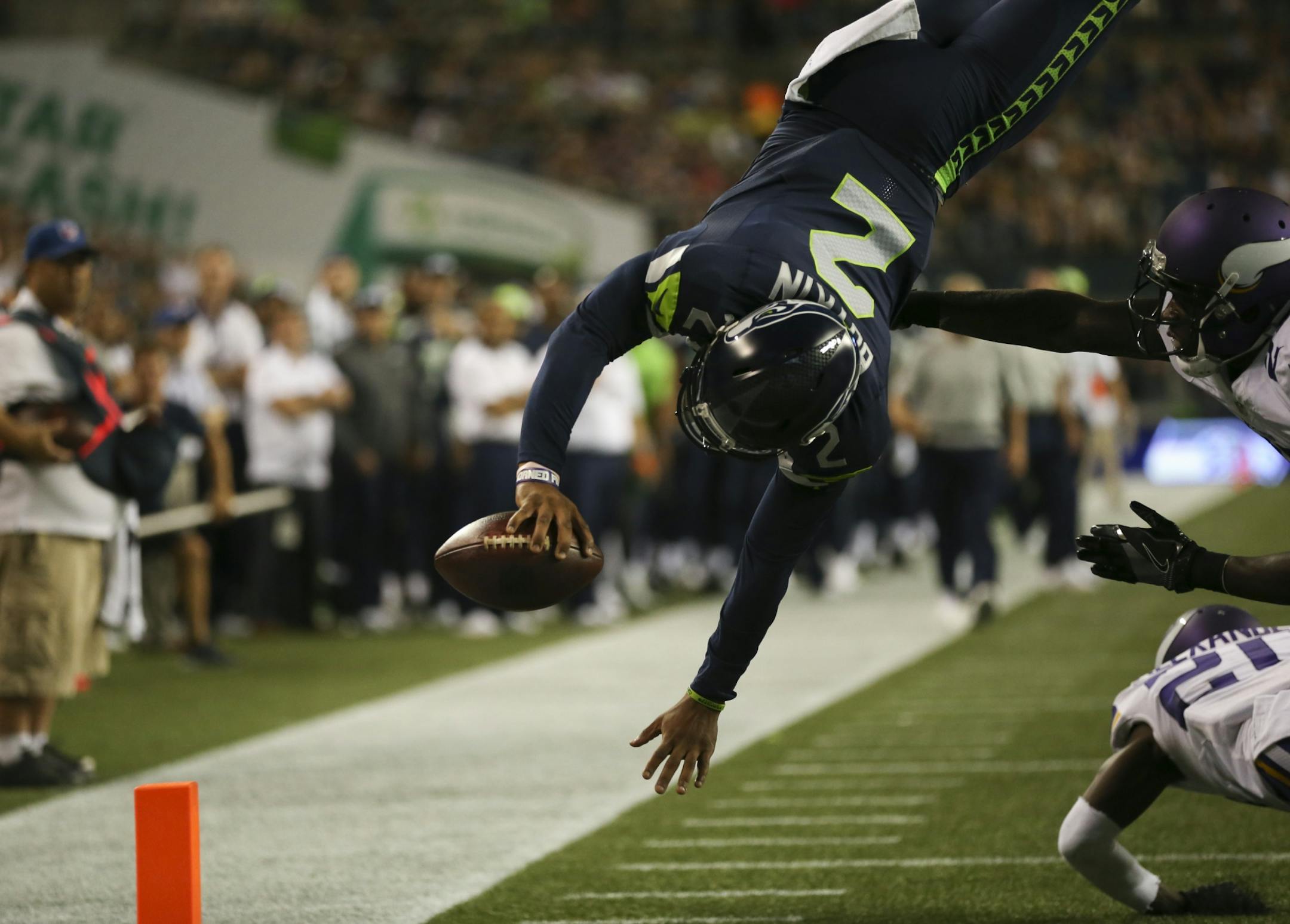 Seattle Seahawks quarterback Trevone Boykin (2) dove into the endzone over Vikings safety Jayron Kearse (27) for a two point conversion after a touchdown in the fourth quarter Thursday night.