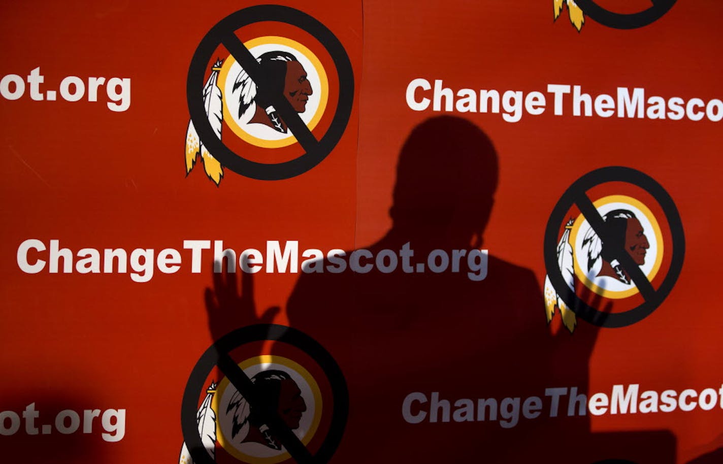 The shadow of Del. Eleanor Holmes Norton, D-D.C., is cast on the backdrop during the Oneida Indian Nation's Change the Mascot symposium, Oct. 7, 2013, in Washington, calling for the Washington Redskins NFL football team to change its name.