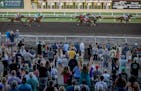 Race fans cheer on the horses during race seven on opening night at Canterbury Park in Shakopee, Minn., on Saturday, May 27, 2023. ] Elizabeth Flores 