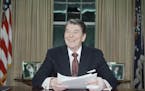 President Ronald Reagan poses for photographers in the Oval Office of the White House, Jan. 11, 1989 after delivering a televised farewell address to 