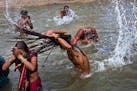 Hindu devotes take a bath in the Godavari River during Kumbh Mela, or Pitcher Festival, in Nasik, India, Saturday, Aug. 29, 2015. According to Hindu m