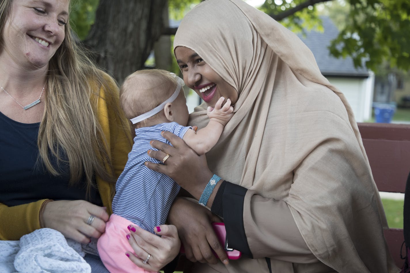 Rachel Johnson left looked on as Ayan Abdi played with Tatum her 5 -month old daughter ,at St. Cloud Mayor Dave Kleis home Tuesday September 19,2017 in St. Cloud, MN. ] JERRY HOLT &#xef; jerry.holt@startribune.com Jerry Holt