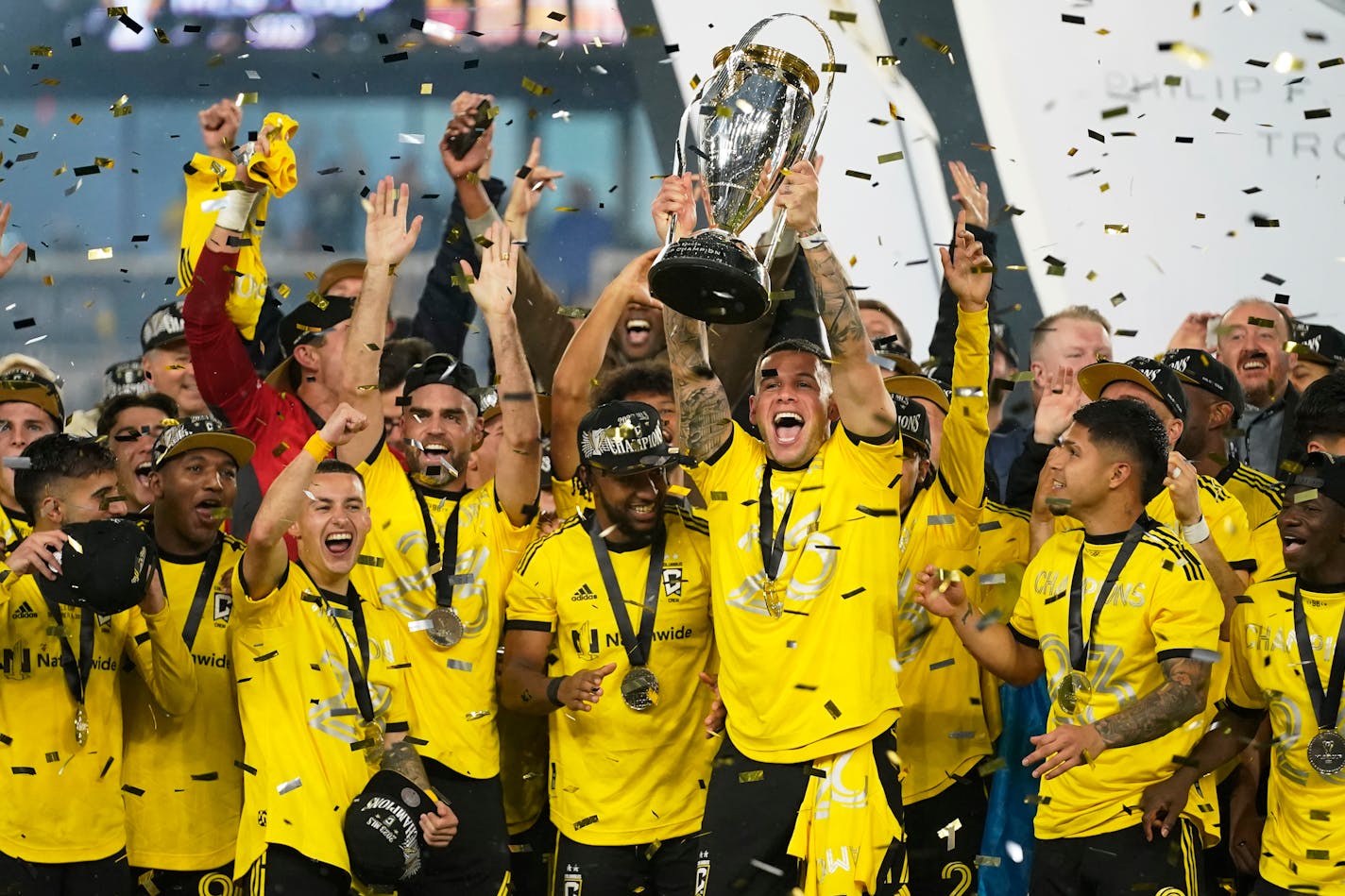 Columbus Crew players celebrate as Christian Ramírez holds up the trophy after defeating Los Angeles FC to win the MLS championship