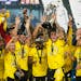 Columbus Crew players celebrate as Christian Ramírez holds up the trophy after defeating Los Angeles FC to win the MLS championship