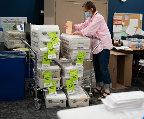 Laurie Mattila added a completed box of ballots to the stack of outgoing mail. Minneapolis Elections & Voter Services has sent out over 85,000 ballots