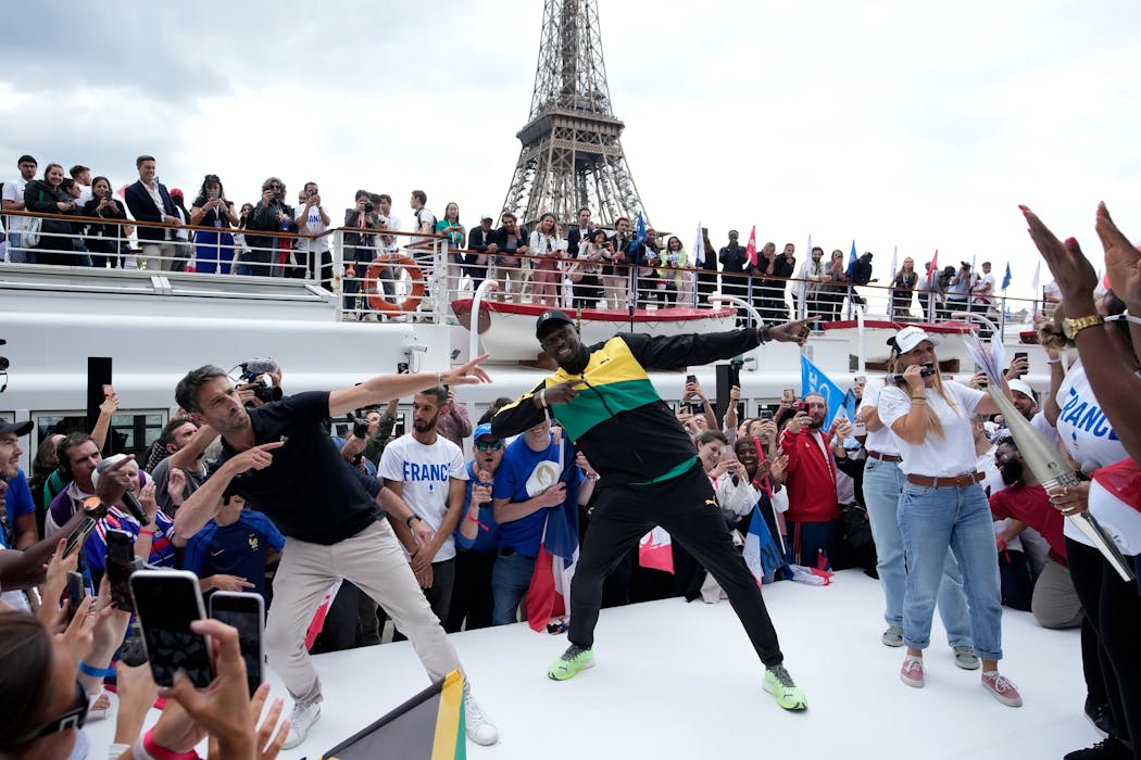 Paris 2024 Olympics Organizing Committee President Tony Estanguet, left, and former Jamaican athlete Usain Bolt performed Tuesday in Paris.