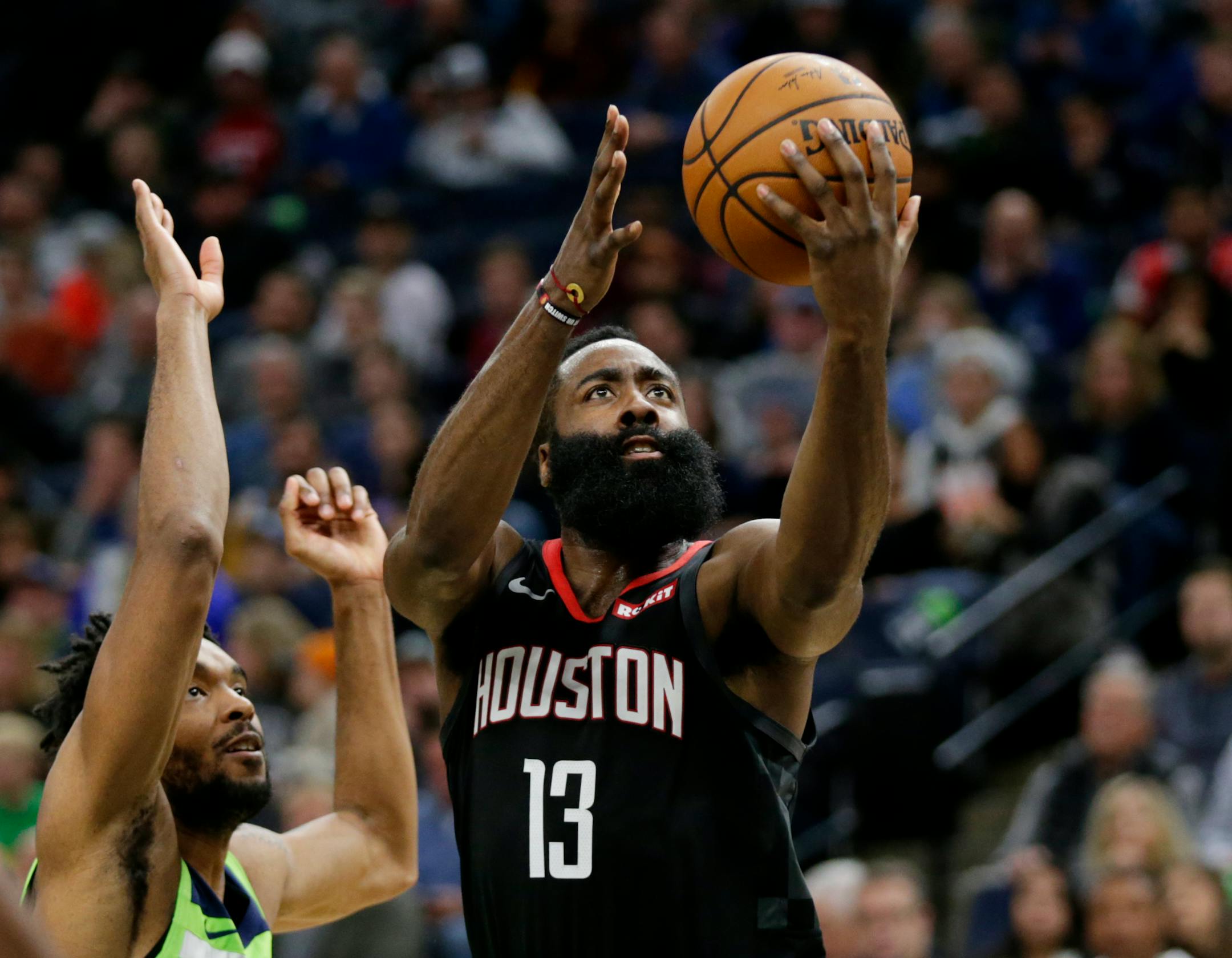 Rockets guard James Harden put up a shot against Timberwolves guard Keita Bates-Diop in the third quarter Saturday night.