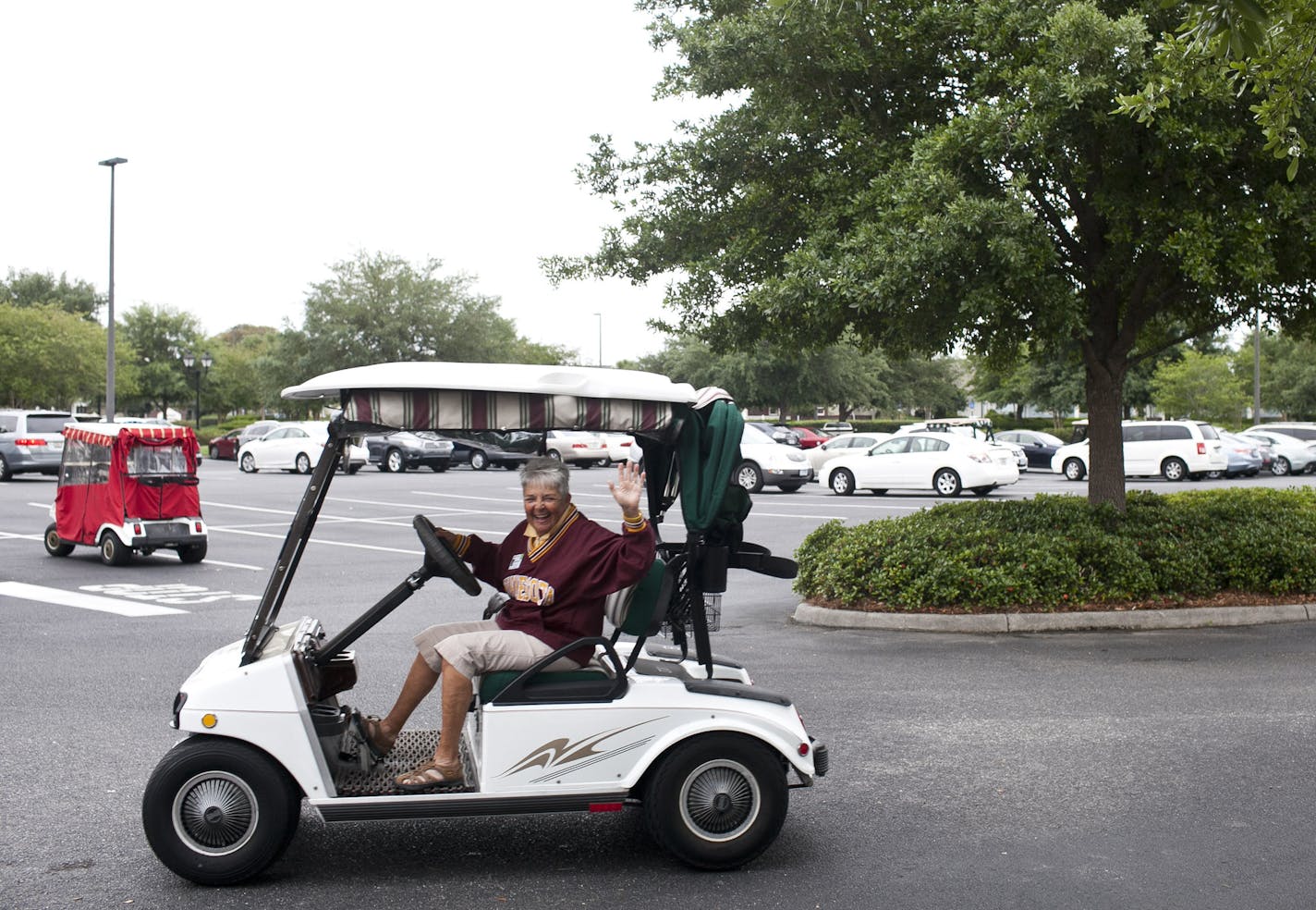 Kathie Gregorich, originally of Duluth, waves goodbye after the Minnesota Club's picnic on April 21, 2014 in The Villages, Florida. Several of the attendees arrived at the picnic in golf carts. (Eve Edelheit/Special To The Star Tribune)