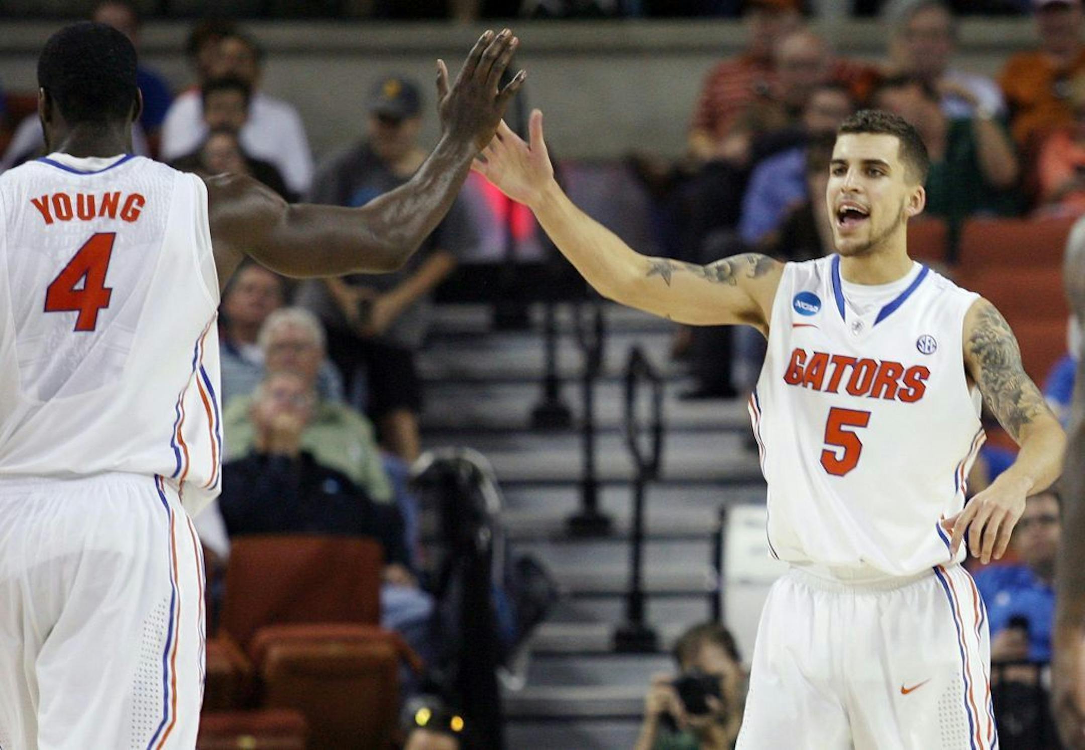 Florida guard Scottie Wilbekin (5) and center Patric Young (4) celebrate after a play against Northwestern State University during a second-round game in the NCAA Men's Basketball Tournament at the Frank Erwin Center in Austin, Texas, Friday, March 22, 2013. Florida won the game 79-47.