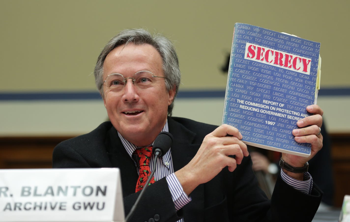 At a U.S. House hearing on Dec. 7, Tom Blanton, director of the National Security Archive at George Washington University, holds up a copy of the 1997 Congressional report on excessive government secrecy. Its recommendations were never fully implemented.