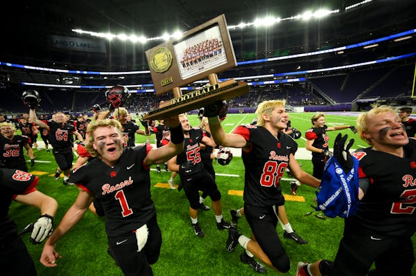 Rocori quarterback Jack Steil (1) and wide receiver Andrew Anderson (88) celebrated their team’s 22-21 OT victory over SMB in the Class 4A state cha