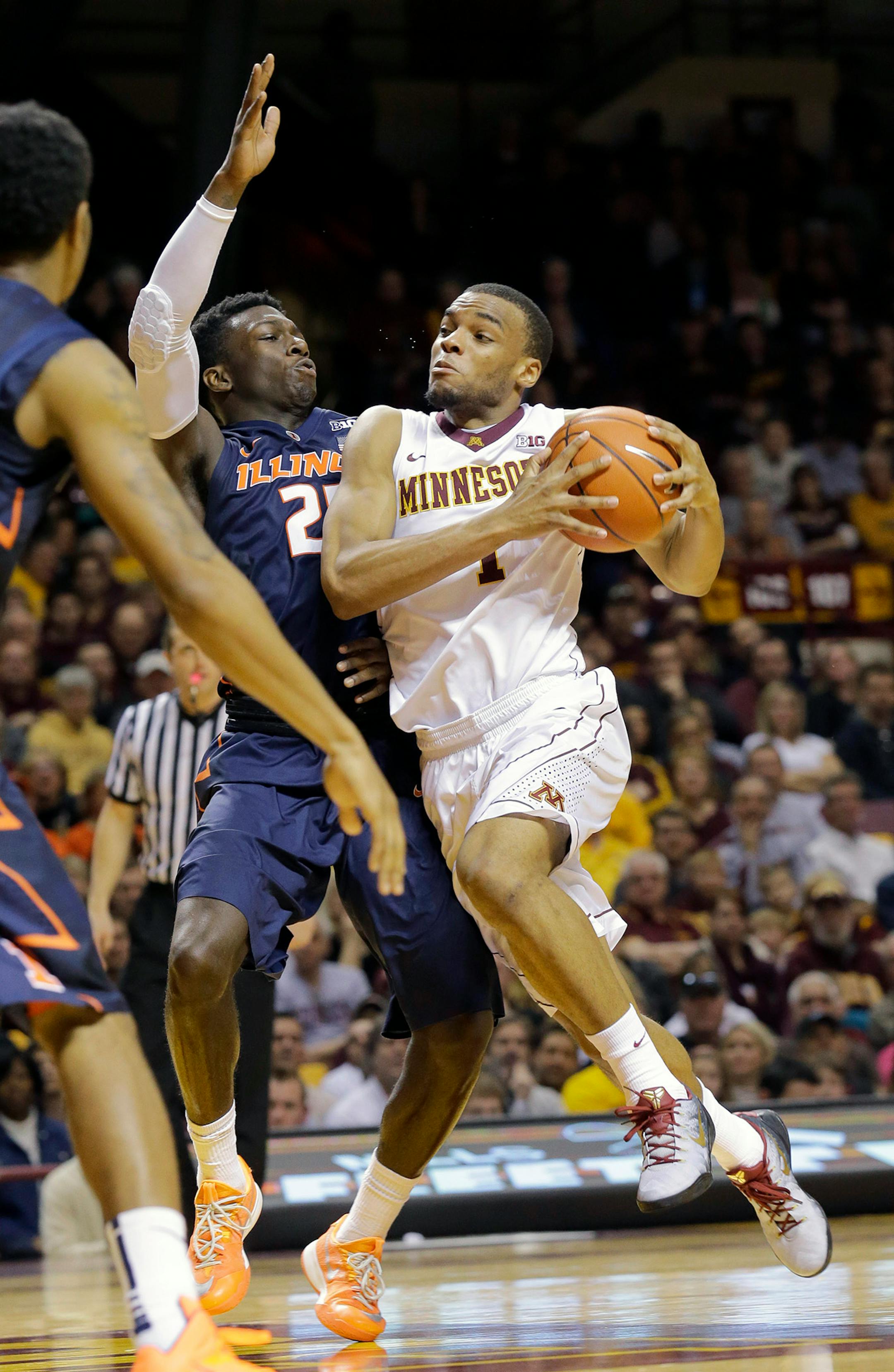 Minnesota guard Andre Hollins, right, drives against Illinois guard Kendrick Nunn, left, during the second half of an NCAA college basketball game in Minneapolis, Saturday, Jan. 24, 2015. Minnesota won 79-71. (AP Photo/Ann Heisenfelt)