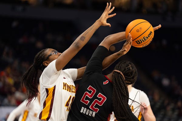 The smothering defense of Gophers forward Nia Holloway (41) was instrumental in Minnesota's 77-69 victory in the first round of the Big Ten women's ba