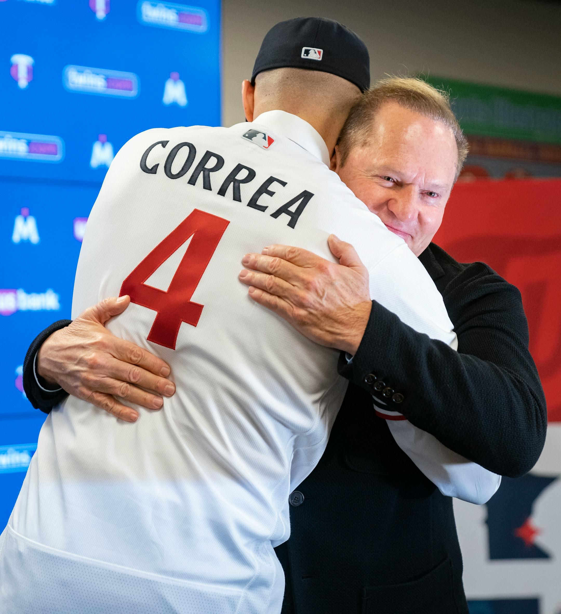 Minnesota Twins shortstop Carlos Correa embraces his agent, Scott Boras, after a press conference.
