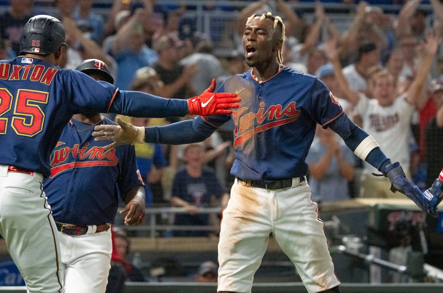 Minnesota Twins left fielder Nick Gordon (1) celebrates with Minnesota Twins player Byron Buxton (25) after scoring the game winning run in the bottom of the tenth inning against the Toronto Blue Jays after Minnesota Twins first baseman Tim Beckham (9) hit a walk off single Friday, August 5, 2022 at Target Field in Minneapolis. ]