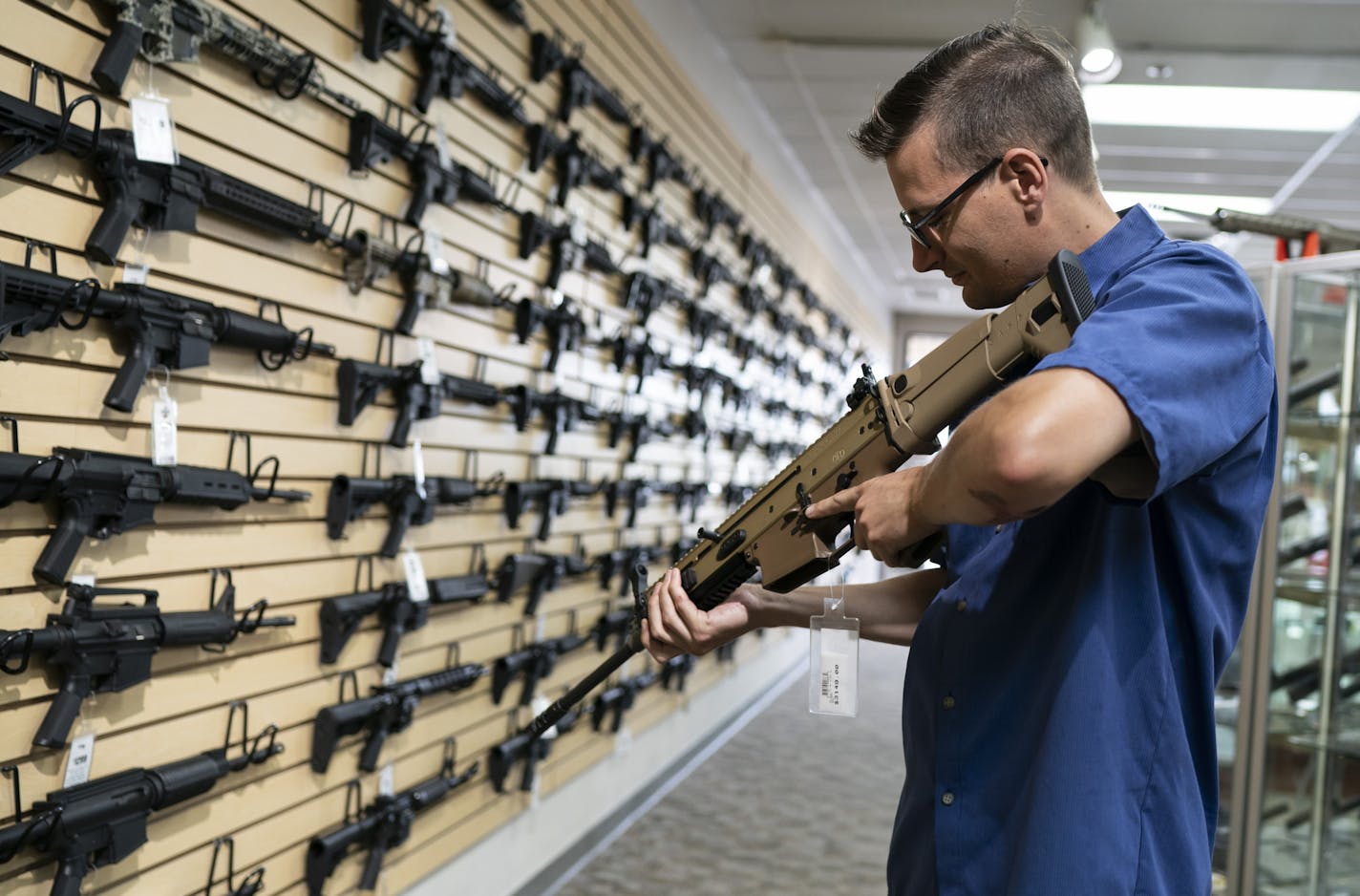 Kyle Rosenquist checked out a semiautomatic rifle at Bill's Gun Shop in Robbinsdale. He plans to join the nearly 290,000 gun-permit holders in the state.