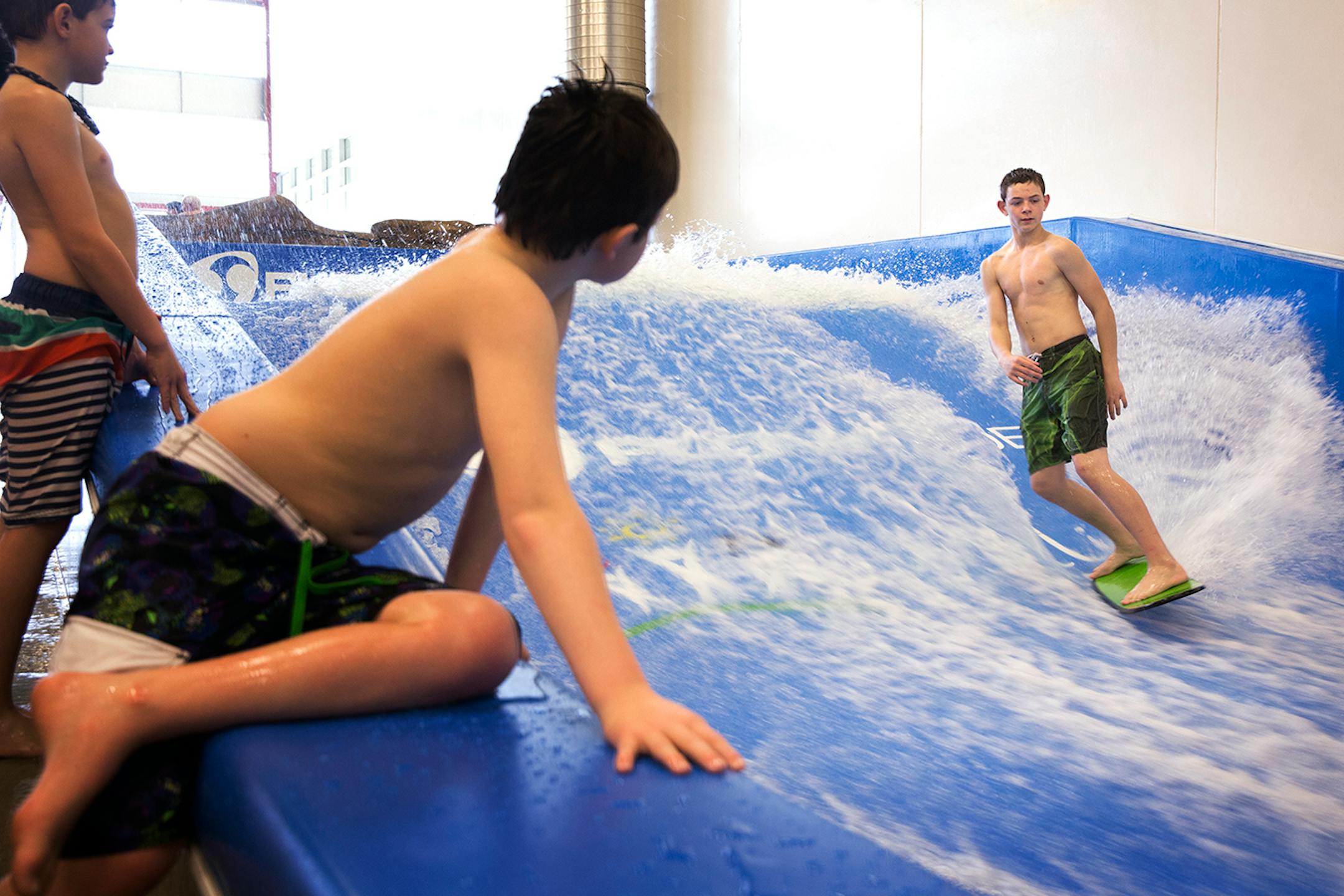 Gage Martin, 13, rides a FlowRider surf simulator at the Williston Area Recreation Center in Williston, North Dakota on Tuesday, March 31, 2015.