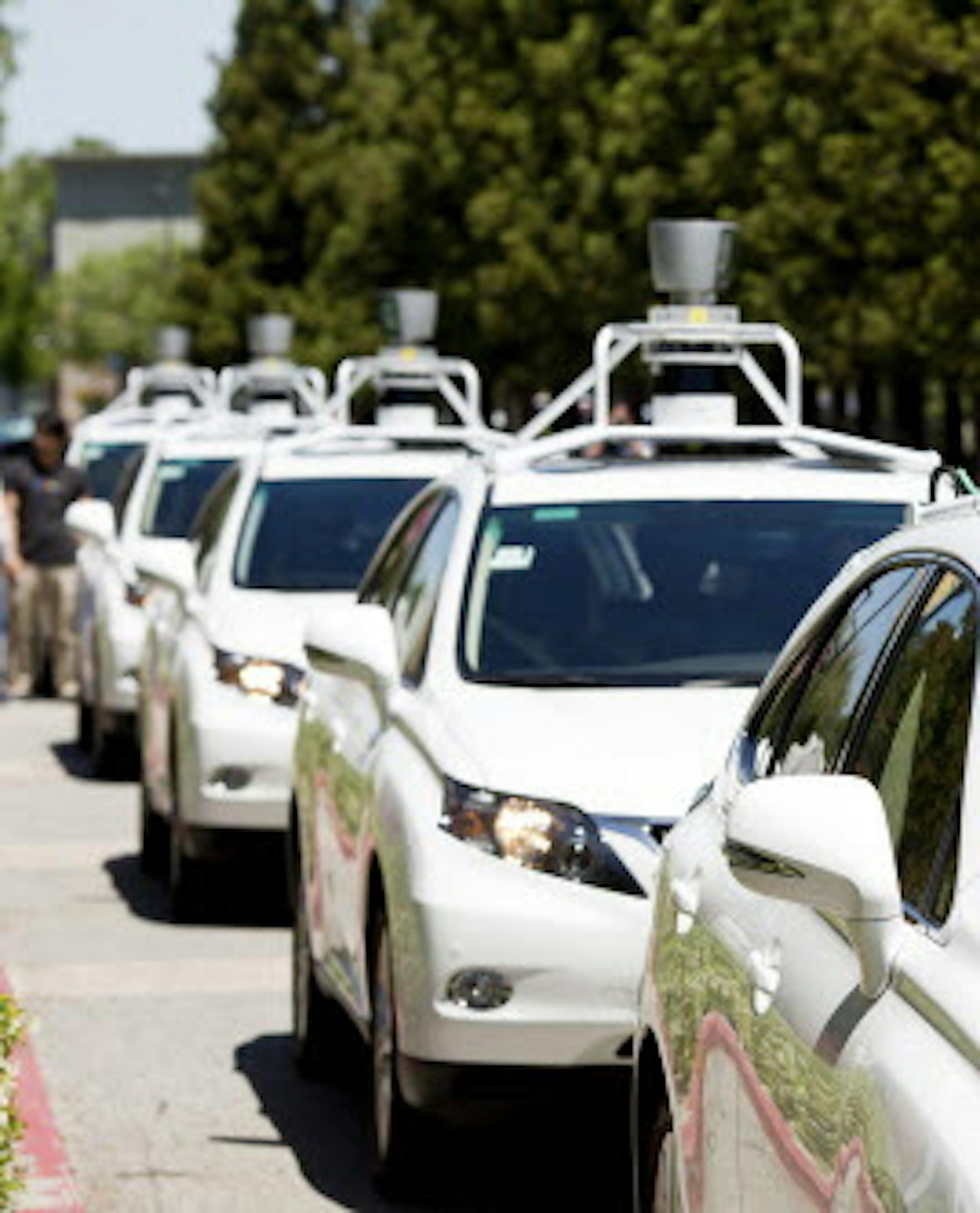A fleet of Google self-driving cars line up for demonstrations during a media event at the Computer History Museum in Mountain View, Calif., May 13, 2014. Driverless cars are supposed to be much safer than cars driven by people because they don‚Äôt make human errors, but legal issues connected to driverless cars have raised many questions and emotion may prove a greater obstacle to their acceptance. (Jason Henry/The New York Times) ORG XMIT: MIN2014052922301728