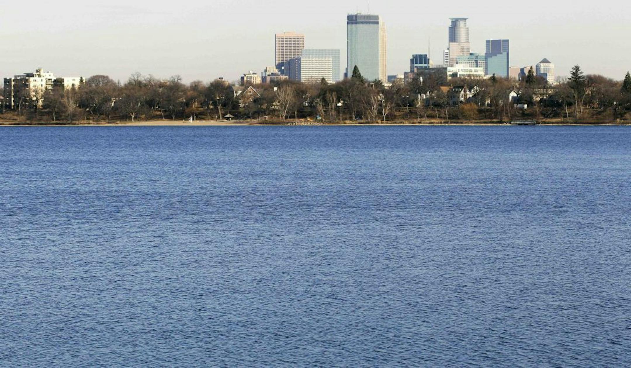 The city of Minneapolis skyline rises Tuesday, Nov. 13, 2012 in the distance behind Lake Calhoun. A newly redistricted precinct map shows 3B is located entirely in the eastern half of Lake Calhoun in Minnesota. City Clerk Casey Carl says the watery precinct is the "unintentional result of a programming error" made in drawing new ward boundary lines.