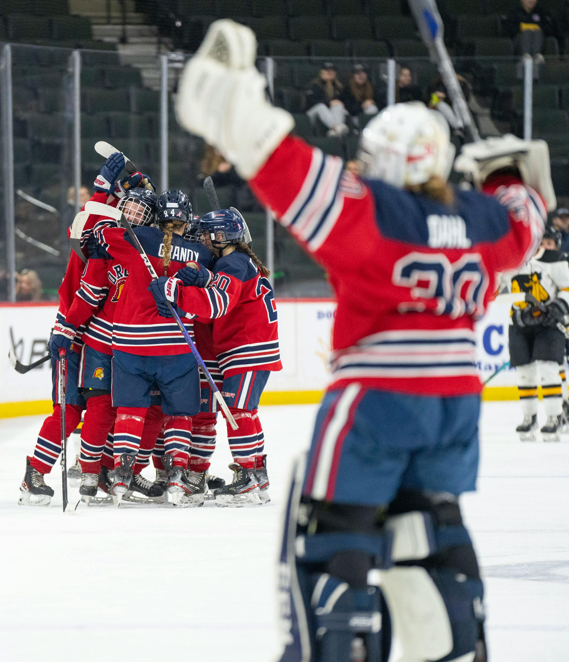 Orono players swarm forward Zoe Lopez (10) after she scored a goal against Warroad in the first period.