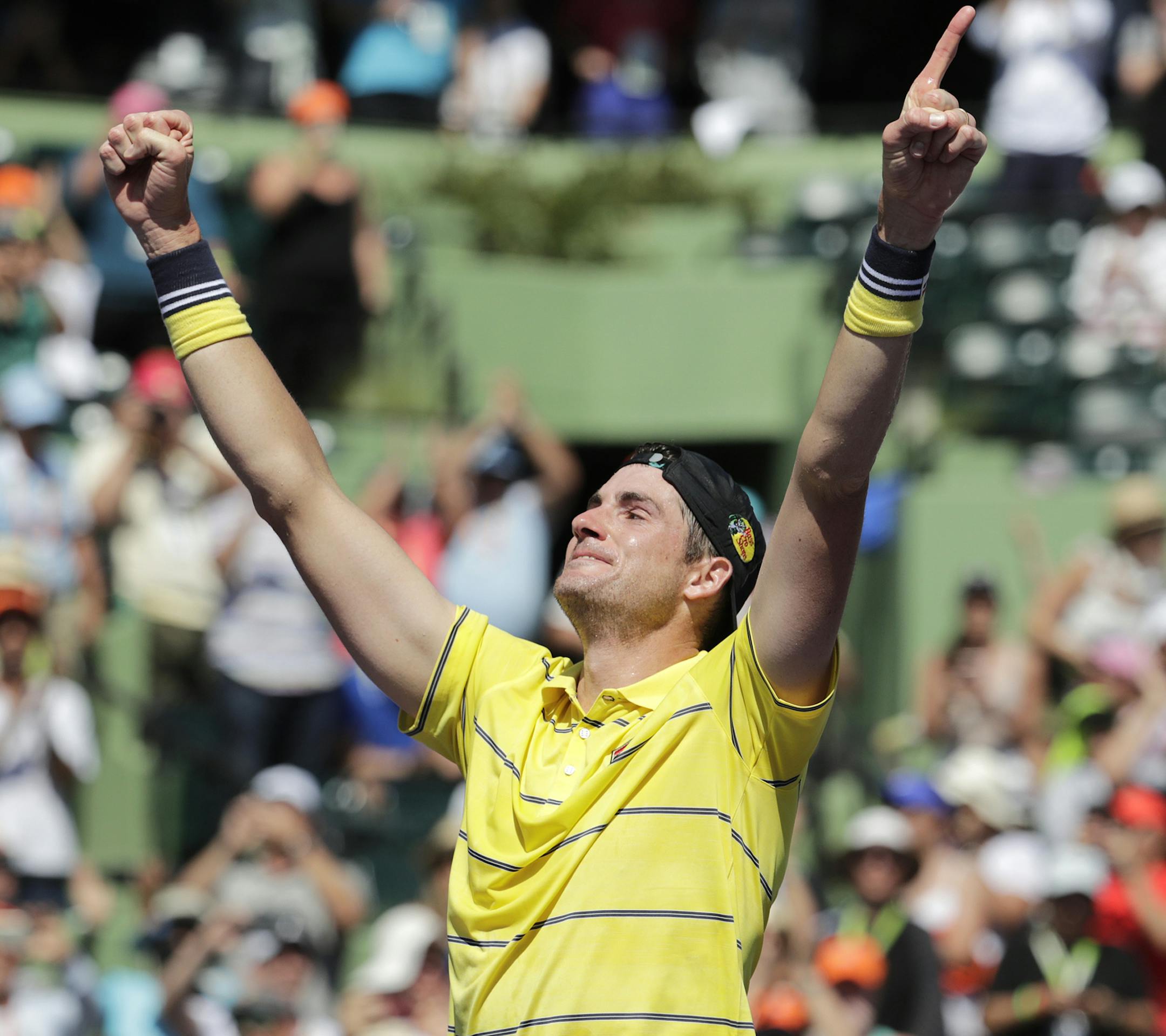 John Isner celebrates after defeating Alexander Zverev, of Russia, in the final at the Miami Open tennis tournament, Sunday, April 1, 2018, in Key Biscayne, Fla. Isner won, 6-7 (4), 6-4, 6-4. (AP Photo/Lynne Sladky)