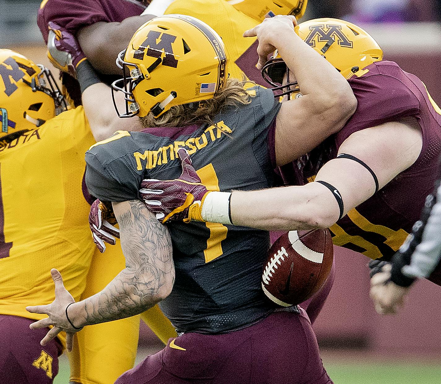 Noah Hickcox (91) strip sacked quarterback Vic Viramontes (7) during the U's spring football game.