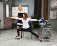 Instructors Jodi Sussner, standing, and Kim Waters demonstrate a pose from a Wellbeats class in chair yoga that was released in 2016 and currently is 