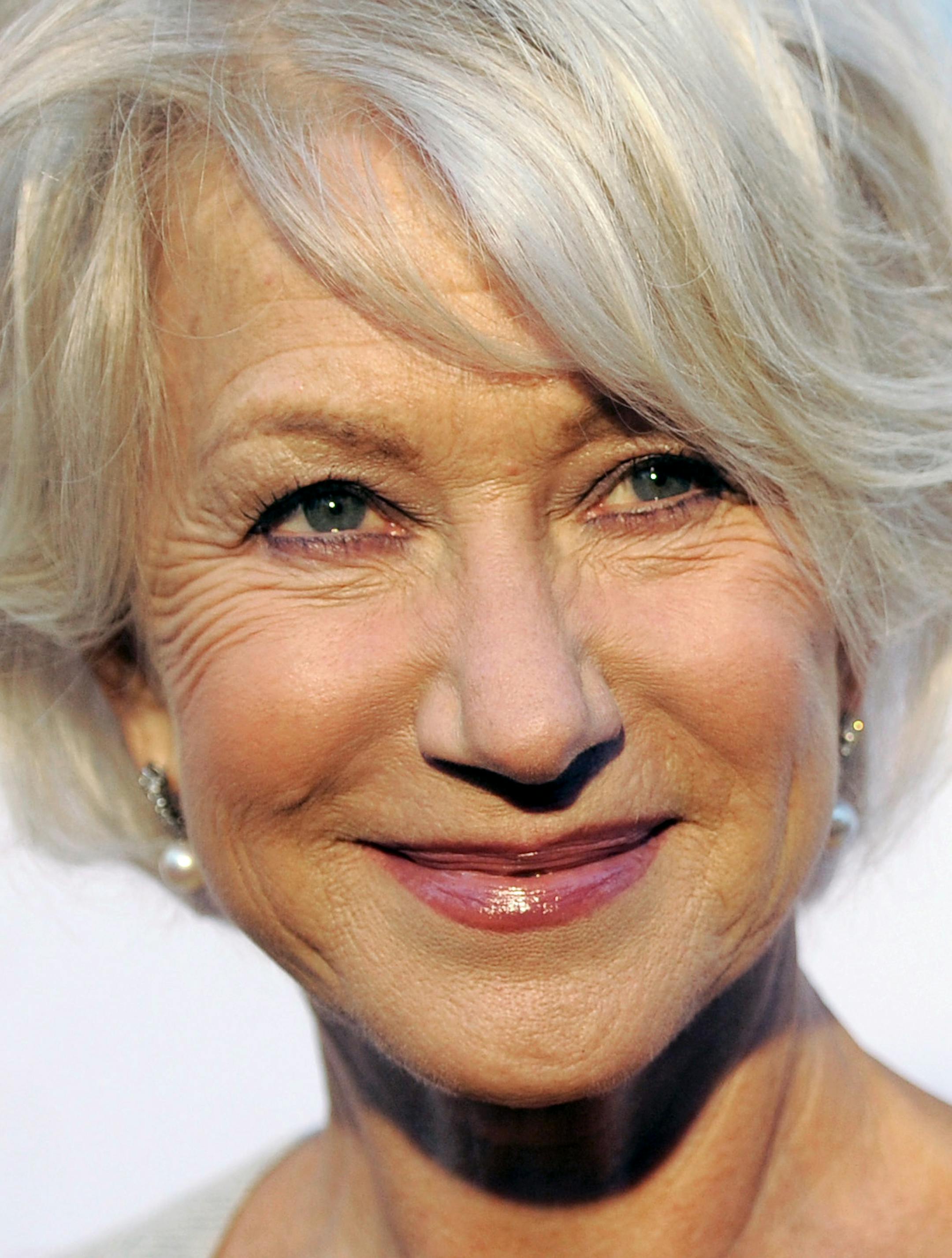 FILE - In this June 17, 2011 file photo, actress Helen Mirren poses at the opening of the 90th season of the Hollywood Bowl in Los Angeles. Gray heads have been popping up on runways and red carpets, on models and young celebrities for months. There's Lady Gaga and Kelly Osbourne _ via dye _ and Hollywood royalty like Oscar-winning British actress Helen Mirren. (AP Photo/Chris Pizzello, file)